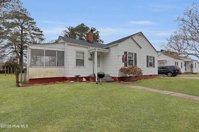 view of front facade featuring a sunroom and a front yard