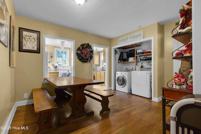 dining room with dark wood-type flooring and washing machine and clothes dryer