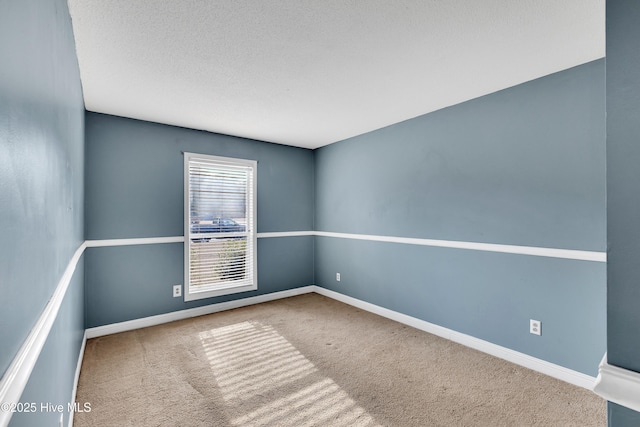 carpeted empty room with a textured ceiling