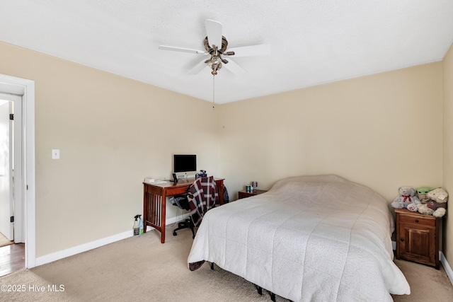 bedroom featuring light colored carpet and ceiling fan