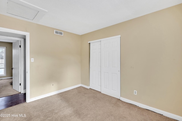 unfurnished bedroom featuring a closet and carpet flooring