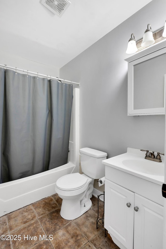 full bathroom with vanity, tile patterned floors, shower / bath combo with shower curtain, and toilet