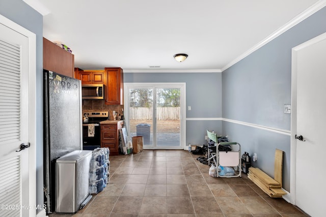 kitchen with crown molding, light tile patterned floors, decorative backsplash, and stainless steel appliances