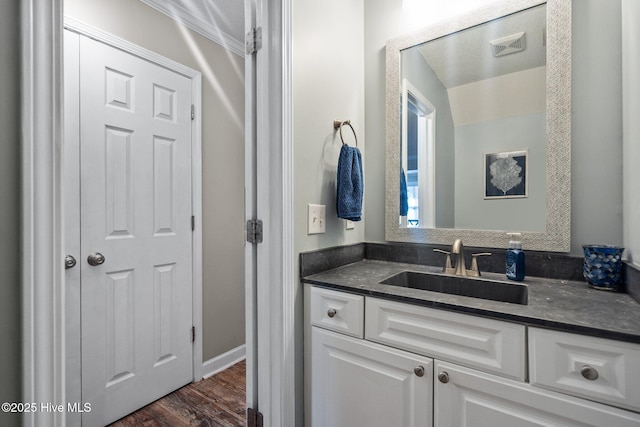 bathroom featuring hardwood / wood-style flooring and vanity