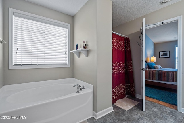 bathroom featuring separate shower and tub and a textured ceiling