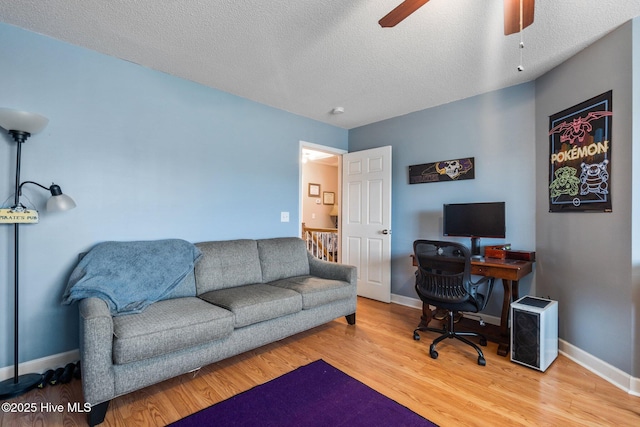 office space featuring a textured ceiling, wood-type flooring, and ceiling fan