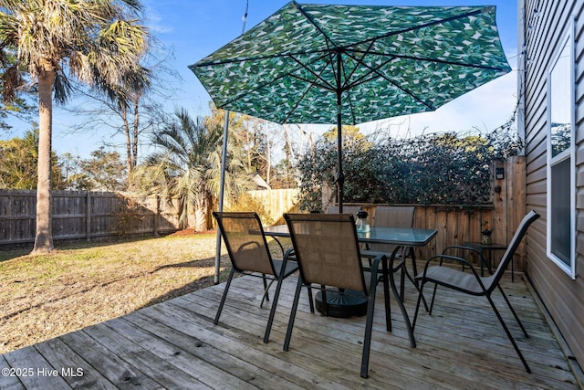 wooden terrace featuring a lawn