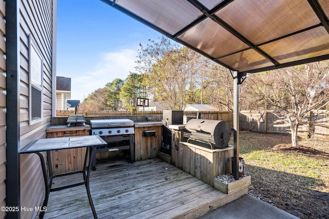 wooden terrace with grilling area and exterior kitchen