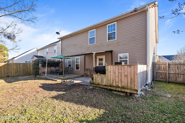 back of house with a deck