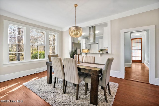 dining room with wood-type flooring and a chandelier