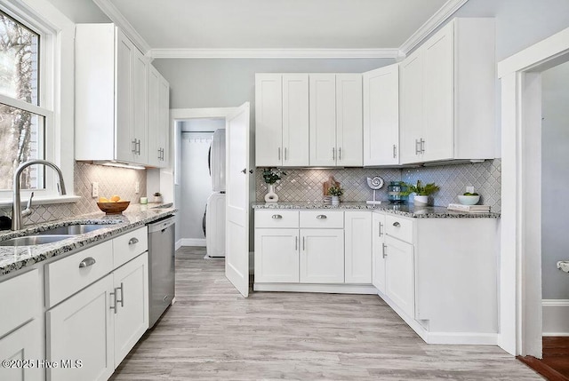 kitchen with sink, stainless steel dishwasher, white cabinets, and light stone counters