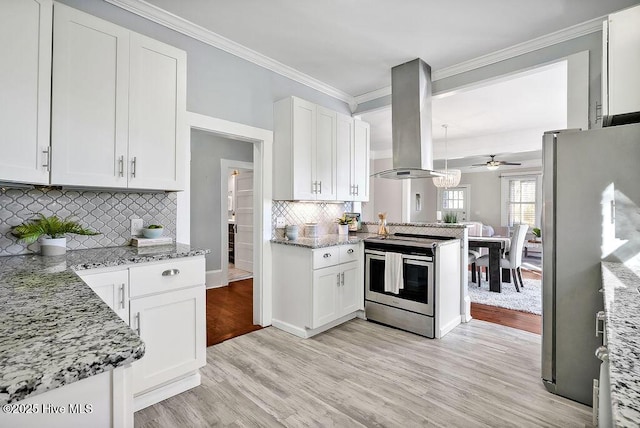 kitchen featuring white cabinetry, island exhaust hood, ornamental molding, light stone counters, and stainless steel appliances