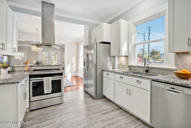 kitchen featuring sink, stainless steel appliances, island range hood, ornamental molding, and white cabinets