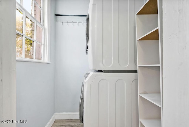 interior space with light hardwood / wood-style floors and stacked washer and clothes dryer