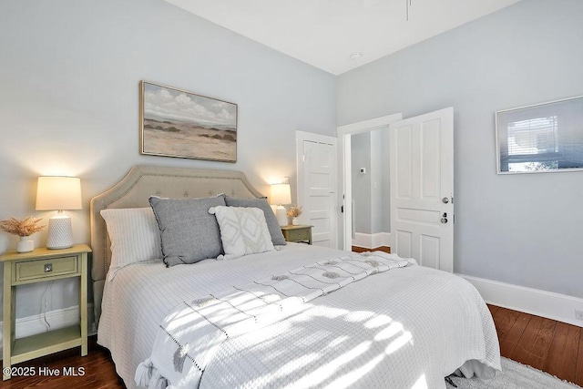 bedroom with dark wood-type flooring