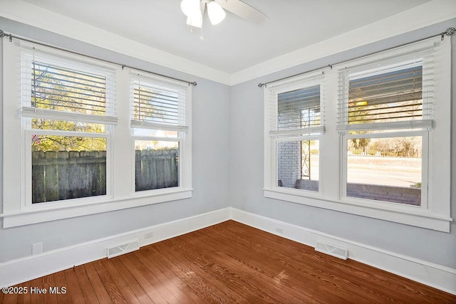 unfurnished room with ceiling fan and hardwood / wood-style floors