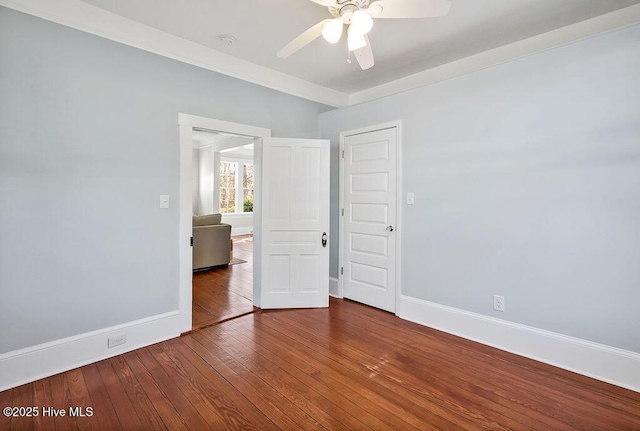 empty room featuring ceiling fan and hardwood / wood-style floors