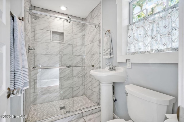 bathroom with toilet and an enclosed shower