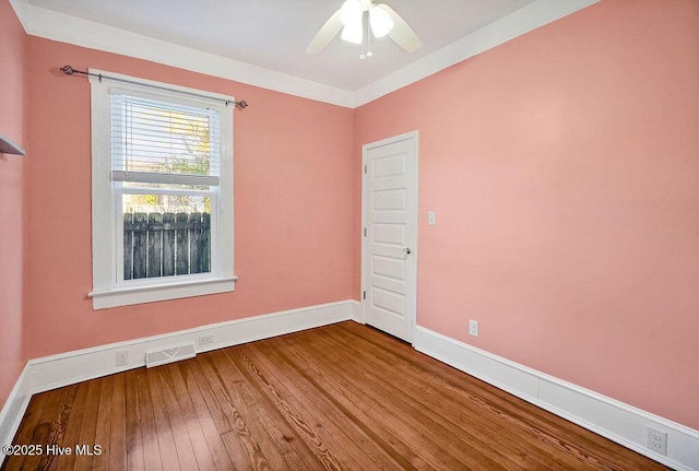 empty room featuring hardwood / wood-style flooring and ceiling fan