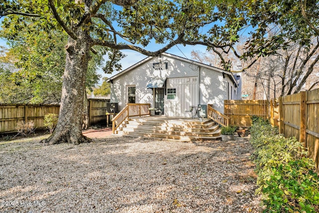 back of property featuring a wooden deck