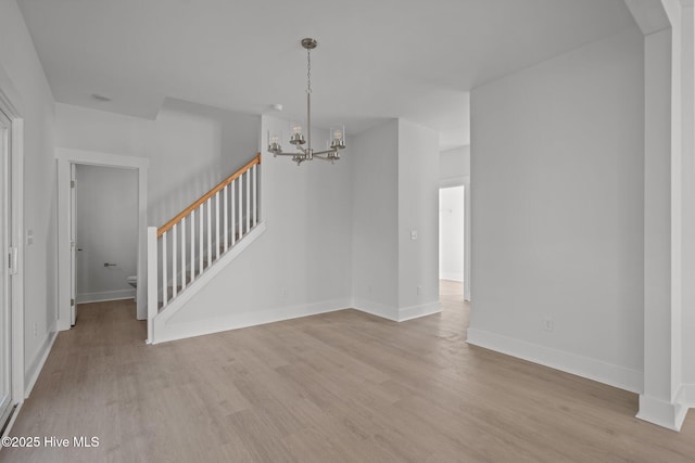 interior space featuring an inviting chandelier and light wood-type flooring