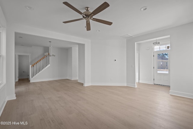 unfurnished living room featuring ceiling fan and light wood-type flooring