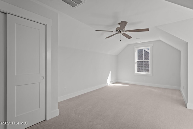 bonus room with light carpet, vaulted ceiling, and ceiling fan