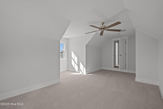 bonus room with ceiling fan, vaulted ceiling, and light carpet