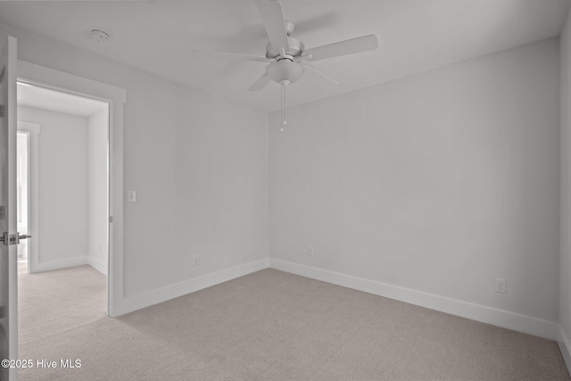 spare room featuring ceiling fan and light colored carpet