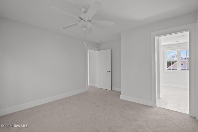 carpeted spare room with ceiling fan