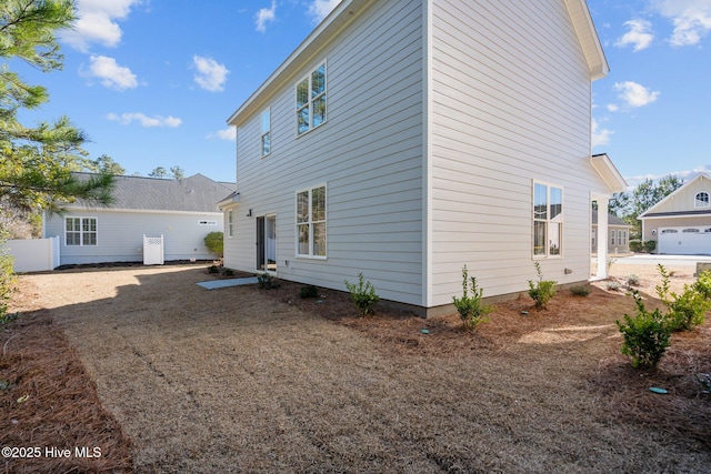 rear view of property featuring a garage