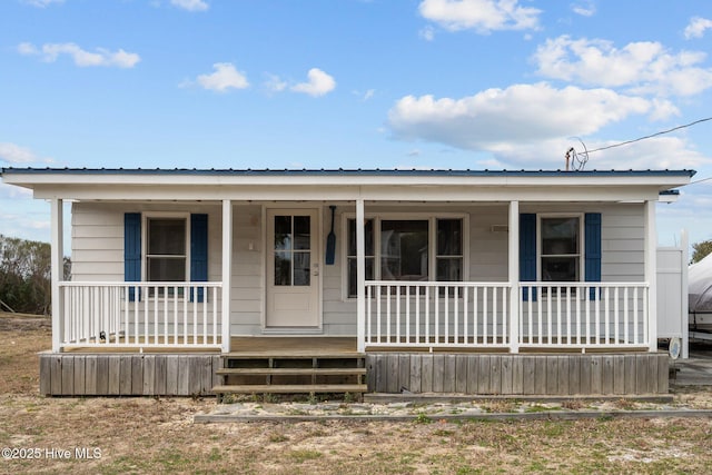 view of front of property featuring a porch and metal roof