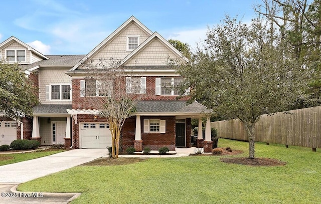 craftsman house featuring a garage, covered porch, and a front lawn