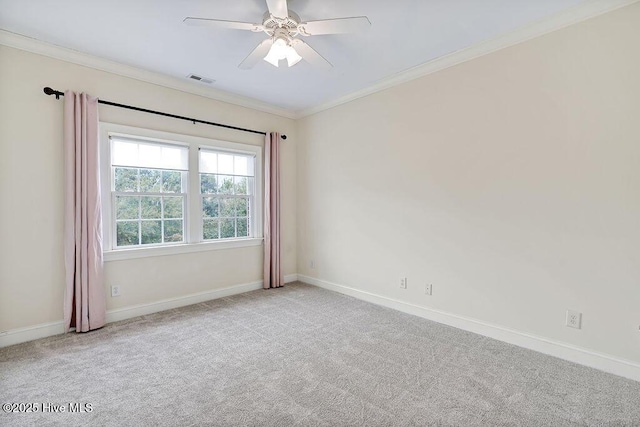 carpeted empty room with crown molding and ceiling fan