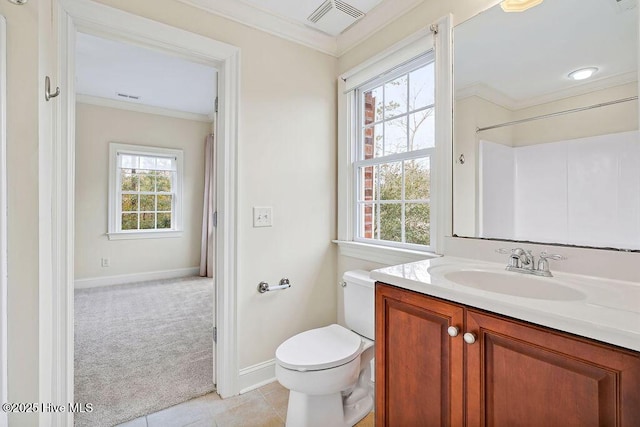 bathroom with ornamental molding, a wealth of natural light, vanity, and toilet