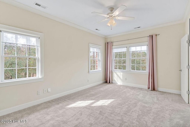 carpeted spare room with ornamental molding and ceiling fan