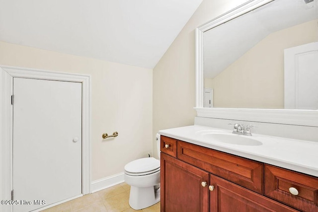 bathroom featuring vanity, toilet, and vaulted ceiling