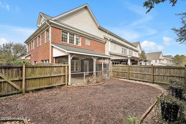 rear view of property featuring a patio area, a sunroom, and ceiling fan