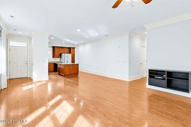 unfurnished living room with crown molding, light hardwood / wood-style floors, and ceiling fan