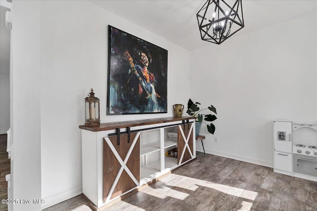 interior space featuring hardwood / wood-style flooring and an inviting chandelier