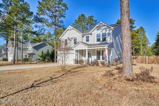 craftsman-style house with a garage, a front lawn, and a porch