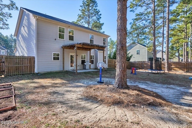 back of house featuring a trampoline and a patio