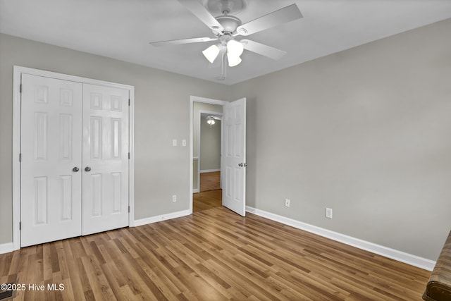 unfurnished bedroom featuring light hardwood / wood-style floors, a closet, and ceiling fan