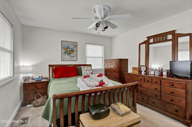 bedroom featuring light carpet and ceiling fan