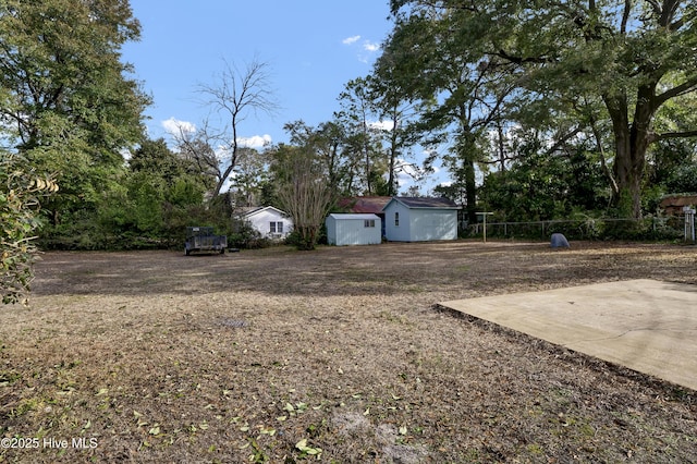 view of yard featuring a shed and a patio