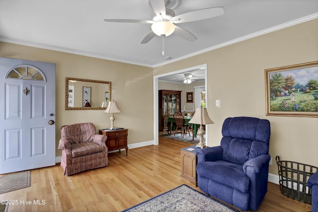 living room featuring ornamental molding and light hardwood / wood-style flooring