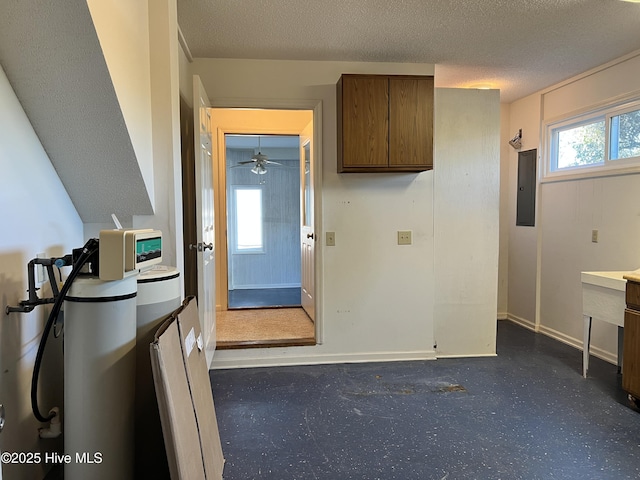 kitchen with electric panel and a textured ceiling