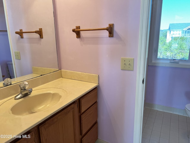 bathroom with vanity, tile patterned floors, and toilet