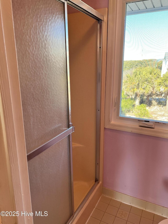 bathroom featuring tile patterned floors and a shower with door