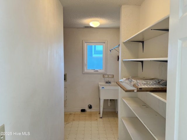 laundry area featuring a textured ceiling